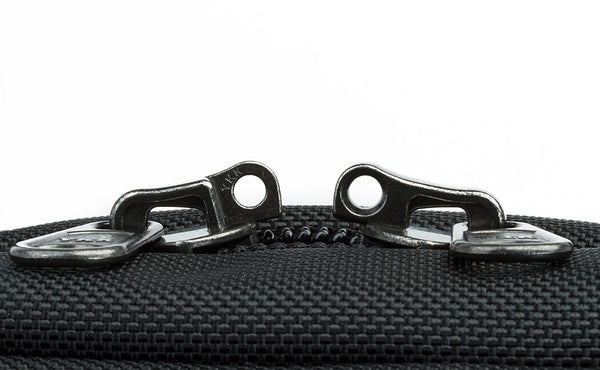 The locking zippers on a Black 525 Ballistic Western Flyer separated to show the individual openings on each of the two zippers.